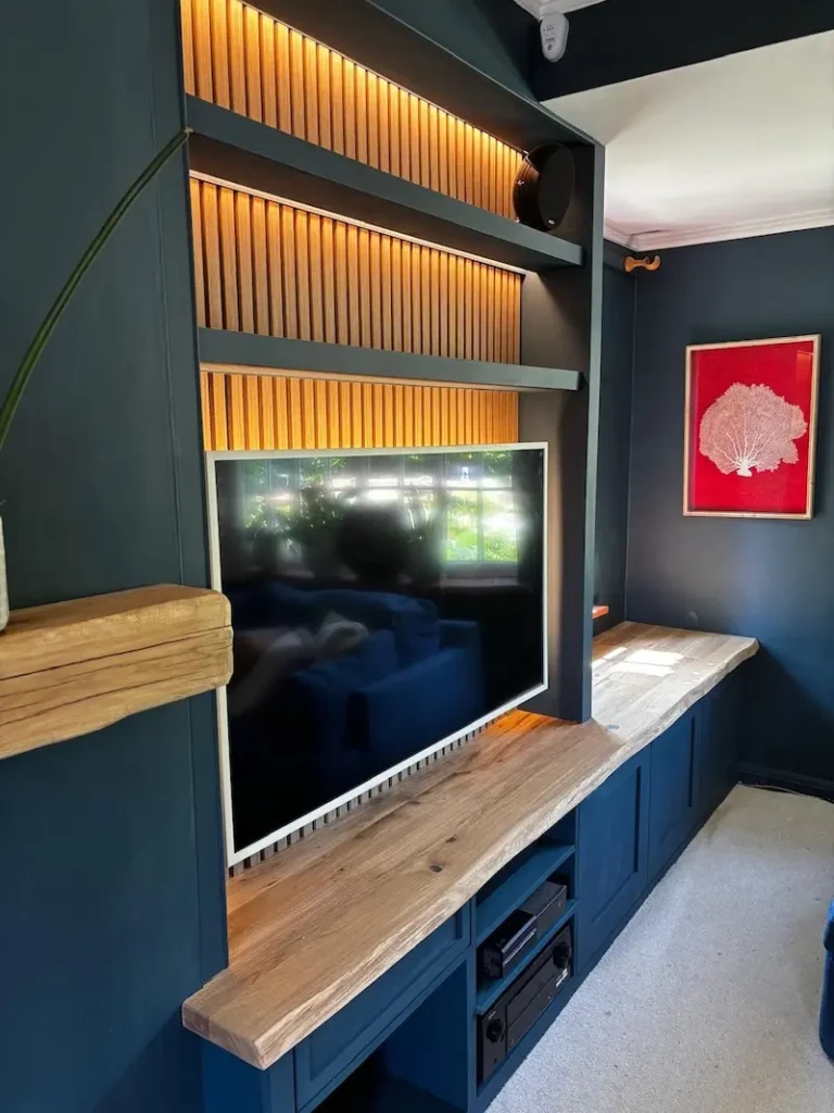 Custom designed entertainment sytstem with backlighting and waney edge oak worktop