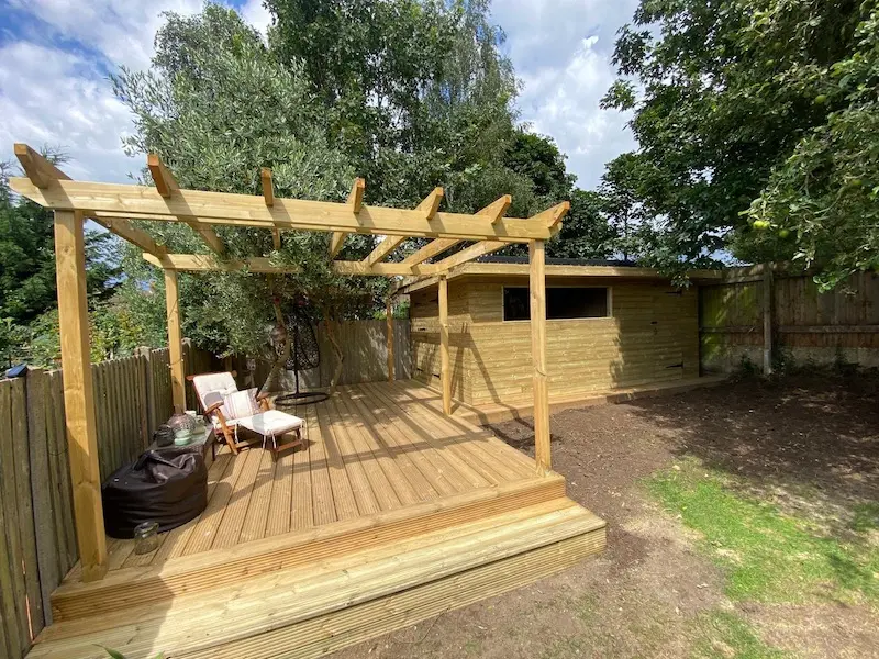 Pergola decking and shed storage in seveoaks purpose built around existing olive trees
