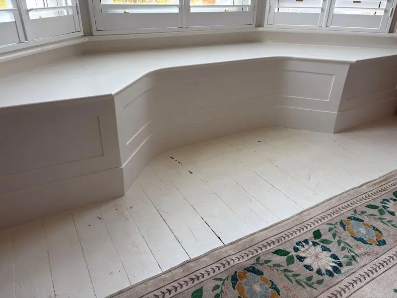 Bespoke built in seating designed around a bay window