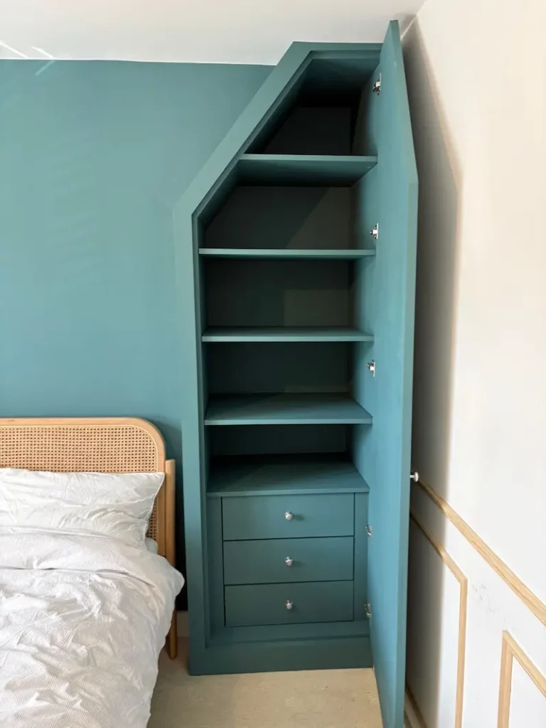 Fitted wardrobe built into alcove with slanting top