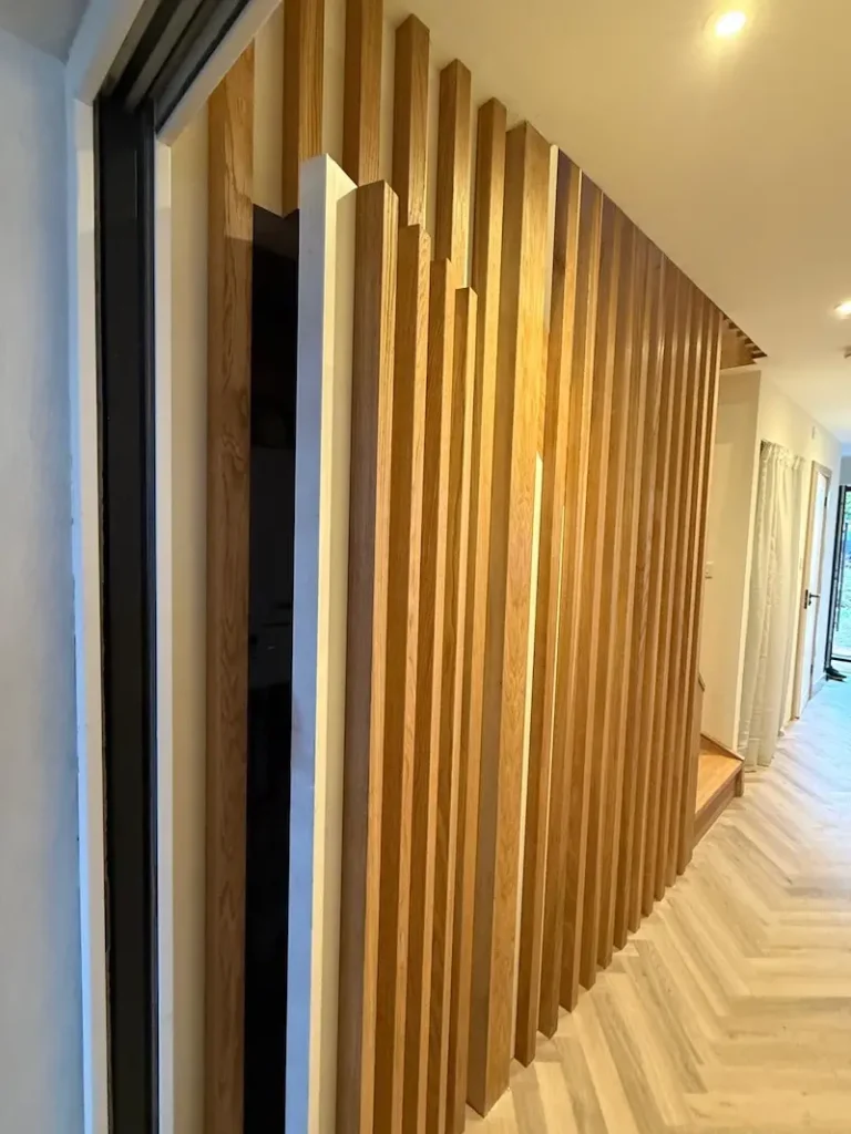 Slatted oak concealed understairs cupboard storage in chislehurst