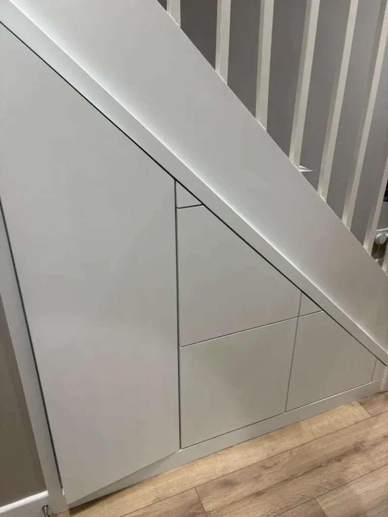 Understairs storage in a small space designed to seamlessly integrate with existing decor